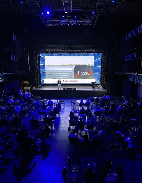 Vadym Melnyk presenting Dronehub on stage to a full audience